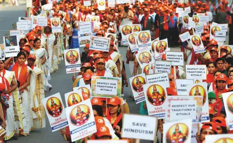  ?? Reuters ?? Women at a protest rally in Ahmedabad, Gujarat, against a Supreme Court ruling revoking the ban on women entering the Sabarimala temple. The Left Democratic Front government in Kerala has said that it has to abide by the apex court’s ruling.