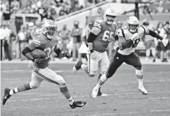  ??  ?? Miami Dolphins running back Kenyan Drake carries the ball for the game-winning touchdown in the fourth quarter of their NFL game against the New England Patriots at Hard Rock Stadium in Miami on Sunday. The Dolphins won 34-33. — Reuters