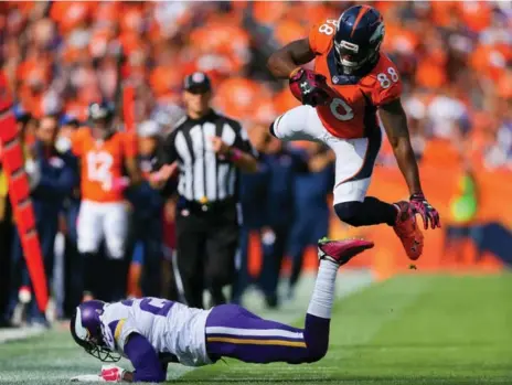  ?? JUSTIN EDMONDS/GETTY IMAGES ?? Denver’s Demaryius Thomas flies through the air after being hit by Vikes cornerback Terence Newman on Sunday afternoon.