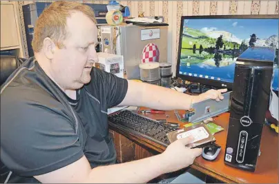  ?? SHARON MONTGOMERY-DUPE/CAPE BRETON POST ?? Paul Burchell of New Waterford, owner of Island Friendly Computers at 3397 Plummer Avenue, works on a computer repair in his shop at 3397 Plummer Ave. Burchell, who sells and repairs computers, laptops and other computer related products, said he chose...