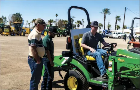  ?? VINCENT OSUNA PHOTO ?? Seth Hilfiker, 15, (right) tries out a compact tractor during the first annual Imperial Valley Ag Expo held at the IV Fairground­s in Imperial on Saturday.