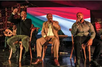  ?? — AFP photos by Ahmed Hasan ?? Sudanese artists Masoud Fayez, Yasser Temtam and Ahmed Abdalaziz perform at a Sudanese cultural event during the Muslim holy fasting month of Ramadan, in Cairo.