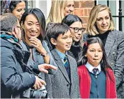  ?? ?? Jeremy Hunt leaves Downing Street for the Commons to deliver his first Budget, above. He was watched, left, by wife Lucia and two of their three children, along with members of staff