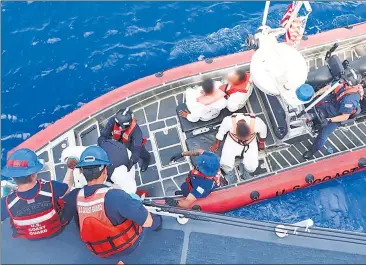  ?? ?? RETURN TO SENDER: The crew of the Coast Guard Cutter Joseph Tezanos repatriate­s migrants Monday to the Dominican Republic after intercepti­ng them aboard separate vessels on the high seas.