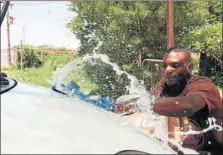  ??  ?? WATER BUSINESS: Gideon Masego washes a car at Majakaneng outside Brits in North West. The community has no running water