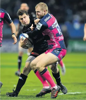  ??  ?? Florian Vialelle of Castres is tackled by Gloucester’s Tom Hudson