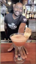  ??  ?? A LA MODE: Tiger’s Milk waiter Raphael Kanyongo with the Apple Pie Martini.