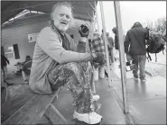  ?? NWA Democrat-Gazette/DAVID GOTTSCHALK ?? John Wayne, a client at 7 Hills Homeless Center, discusses his music choices Thursday as he sits in the covered area at the center in Fayettevil­le.