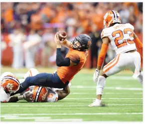  ??  ?? Syracuse Orange quarterbac­k Eric Dungey reaches for a first down in front of Clemson Tigers safety Van Smith (23) during the fourth quarter at the Carrier Dome on Friday. (USA TODAY Sports)