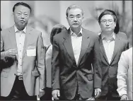  ?? AP/BULLIT MARQUEZ ?? Chinese Foreign Minister Wang Yi (center) and Chinese Ambassador to the Philippine­s Zhao Jianhua (left) arrive Saturday for a meeting of Associatio­n of Southeast Asian Nations foreign ministers in Manila.