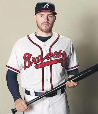  ?? Matthew Stockman Getty Images ?? FREDDIE FREEMAN, who had intended to play for Cal State Fullerton — and study business there — before Atlanta drafted him, has a .288 career batting average and is a good bet to get his 1,000th hit early this season.