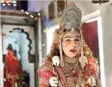  ?? A.M. FARUQUI ?? Durga Bai Majhwar, who is contesting from the Damoh constituen­cy in Madhya Pradesh, dressed up as Goddess Durga for a ritual at Maa Sharda Temple in Maihar on the occasion of Navami.