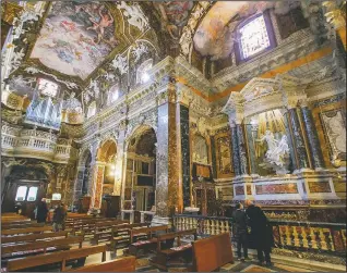  ??  ?? Visitors admire the marble sculptural group “Ecstasy of Saint Teresa” made between 1647 and 1652, by Baroque architect and sculptor Gian Lorenzo Bernini in the Cornaro Chapel of Rome’s Saint Mary of Victory church in Rome.