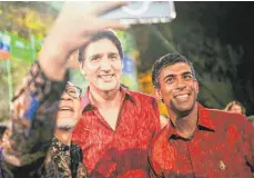  ?? FOTO: KAY NIETFELD/DPA ?? Als wären sie Popstars! In traditione­llen Hemden nehmen Kanadas Premiermin­ister Justin Trudeau (links) und sein britischer Amtskolleg­e Rishi Sunak am Abendessen in Nusa Dua teil.