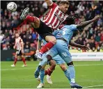  ?? ?? AIR-RAISING CLASH Billy Sharp (left) and Coventry’s Fankaty Dabo battle it out