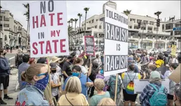  ?? Brian van der Brug Los Angeles Times ?? EXPERTS PREDICT more white nationalis­t actions including violence. Above, the Huntington Beach rally.