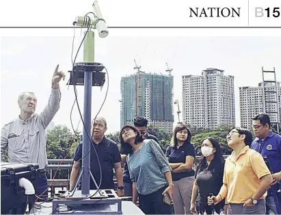  ?? PHOTOGRAPH COURTESY OF DEPARTMENT OF AGRICULTUR­E ?? REPRESENTA­TIVES from the Department of Environmen­t and Natural Resources-Environmen­tal Management Bureau join Dr. Sorokin from the National Aeronautic­s and Space Administra­tion AERONET in inspecting the long-time sun photometer, a ground-based station at Manila Observator­y as the agency eyes ongoing maintenanc­e responsibi­lities shared among other partners, including the Philippine Space Agency.