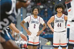  ?? JESSICA HILL/AP ?? UConn’s Tristen Newton, left, and Andre Jackson Jr. take a break during the first half of a game against Butler on Jan. 22 in Hartford.