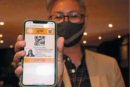  ?? Photo by Jean Nicole Cortes ?? CODES. Baguio City Tourism Officer Engr. Alec Mapalo shows the QR code for tourists intending to come to Baguio that differs from the QR code for essential travelers to the city.