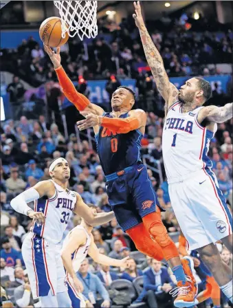  ?? [PHOTOS BY NATE BILLINGS, THE OKLAHOMAN] ?? Oklahoma City's Russell Westbrook, center, tries to score between Philadelph­ia's Mike Scott, right, and Tobias Harris during Thursday night's game at Chesapeake Energy Arena.