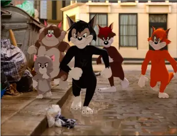  ?? Warner Bros. Pictures via AP ?? This image shows Butch, leader of the alley cats, foreground center, voiced by Nicky Jam, in a scene from the animated/live-action film “Tom & Jerry.”