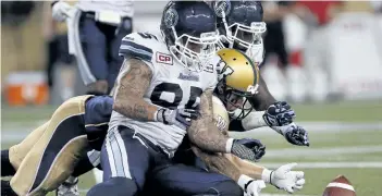  ?? JOHN WOODS/THE CANADIAN PRESS ?? Toronto Argonauts’ Ricky Foley recovers Winnipeg Blue Bombers’ Rory Kohlert’s fumble in Winnipeg in 2015. The Toronto Argonauts released veteran defensive end Ricky Foley on Friday. The six-foot-two, 258-pound Foley was in his second stint with...
