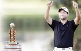  ??  ?? JUBILANT: Alexander Levy of France celebrates besides the trophy after winning the final round at the Porsche European Open at the Golf Resort in Bad Griesbach near Passau, Germany, Sunday. (AP)