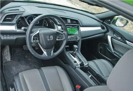  ??  ?? The Honda Civic’s cabin is more refined for 2017, but the touch screen interface is too labour-intensive.