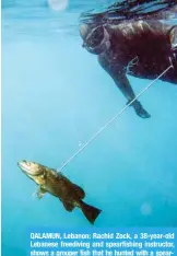  ?? AFP ?? QALAMUN, Lebanon: Rachid Zock, a 38-year-old Lebanese freediving and spearfishi­ng instructor, shows a grouper fish that he hunted with a speargun while diving off on March 4, 2018. —