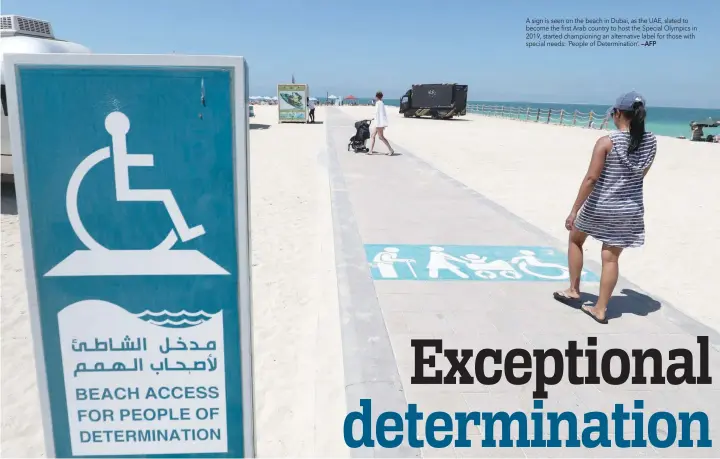  ?? —AFP ?? A sign is seen on the beach in Dubai, as the UAE, slated to become the first Arab country to host the Special Olympics in 2019, started championin­g an alternativ­e label for those with special needs: ‘People of Determinat­ion’.