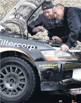 ?? PHOTO: PETER MCINTOSH ?? Roaring to go . . . Otago Polytechni­c automotive engineerin­g student Rick McGuirk watches as New Zealand Rally Championsh­ip scrutineer Dave Robb makes sure a car meets the requiremen­ts for competing in the Otago Rally this weekend.