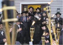  ?? Craig Ruttle / Associated Press ?? Supporters of Rabbi Chaim Rottenberg gather outside his residence in Monsey, N.Y., a day after the knife attack.