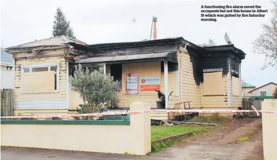  ??  ?? A functionin­g fire alarm saved the occupants but not this house in Albert St which was gutted by fire Saturday morning.