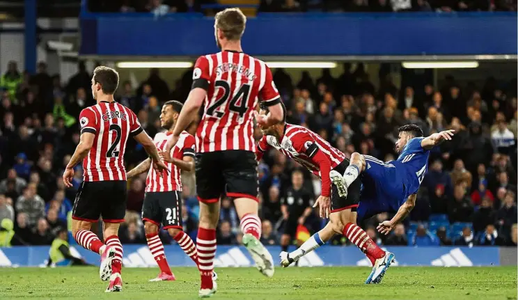  ?? — Reuters / AFP ?? Four is not a crowd: Diego Costa scoring Chelsea’s fourth goal against Southampto­n in the English Premier League clash at Stamford Bridge on Tuesday. Costa (below) giving thanks after his two-goal show.