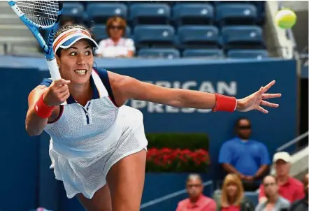  ?? — AFP ?? Flying start: Garbine Muguruza of Spain returning a shot to American Varvara Lepchenko in the first round on Monday.