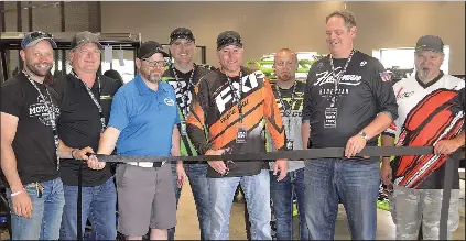  ??  ?? Swift Current Mayor Denis Perrault assisted with the ribbon cutting at CMX Powersport­s on June 23. Customers wre also able to test out the machines on the test track adjacent to the business.