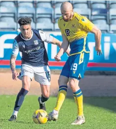  ??  ?? Declan McDaid challenges Shaun Rooney in cup tie.