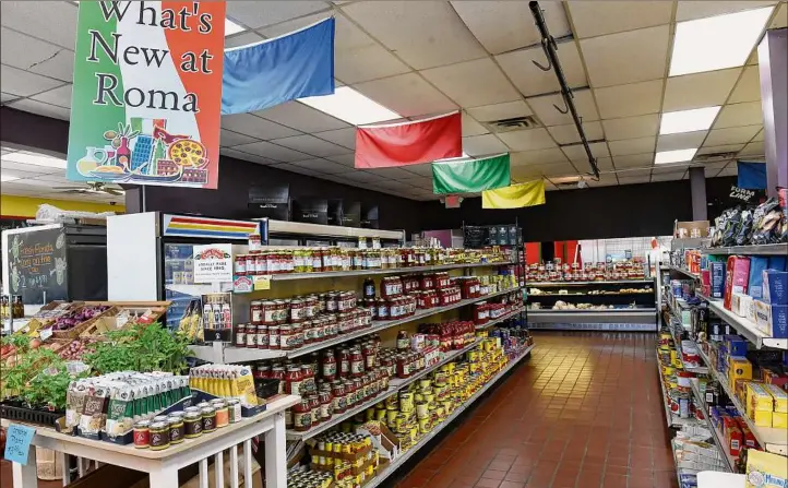  ?? Lori Van Buren / Times Union ?? Roma Foods Importing Co. in Latham, above, and Saratoga Springs is being purchased by Cardona’s Market, an Italian grocery store in Albany.