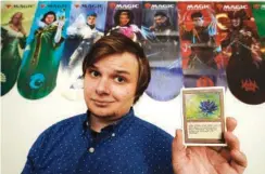  ?? AP PHOTO/CHARLIE RIEDEL ?? Austin Deceder displays a Black Lotus Magic card in his home office Friday in Kansas City, Mo.