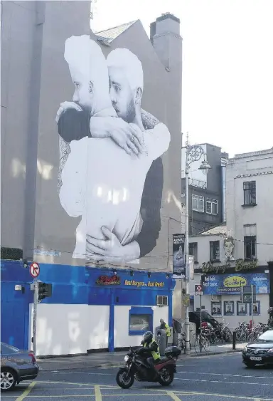  ?? Shawn Pogatchnik / the associated press files ?? A gay-rights mural decorates a building in Dublin. Ireland will hold a referendum on gay
marriage Friday, though homosexual acts were illegal only a generation ago.