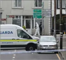  ??  ?? Forensic officers at the scene in Castlerea where Detective Garda Colm Horkan was shot dead on Wednesday night.