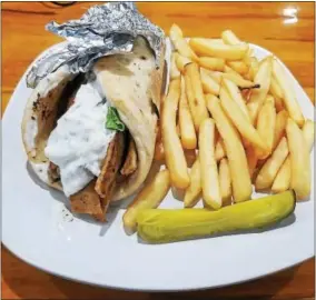  ?? PHOTO PROVIDED ?? A chicken gyro lunch special with fries and a pickle from Good Eats Restaurant.