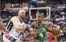  ?? NICK WASS — THE ASSOCIATED PRESS ?? Celtics guard Isaiah Thomas (4) dribbles against Wizards center Marcin Gortat during Game 4 on Sunday.