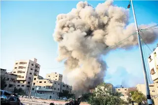  ?? AFP PHOTO ?? CLOUD OF CONFLICT
A plume of smoke rises after Israeli forces bombard Al-Daraj neighborho­od in Gaza City, northern Gaza Strip, on Tuesday, April 16, 2024.