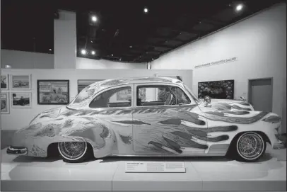  ?? The Associated Press ?? OUR FAMILY CAR: “Our Family Car,” a customized 1950 Chevrolet Sedan by Gilbert “Magu” Lujan, is displayed June 29 during an exhibition titled “The High Art of Riding Low” at the Petersen Automotive Museum in Los Angeles.