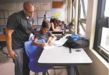  ??  ?? Truss visits with Josue Mensivar in Visitacion Valley’s seventh-grade computer science class.