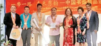  ??  ?? CHINESE ARTISTS donated the proceeds of their paintings to Love the Children Foundation, Inc. received by Davao City Chief of Staff lawyer Raul Nadela, Jr.