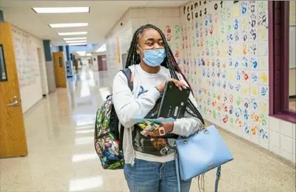  ?? Andrew Rush/Post-Gazette ?? Eleventh grader Amare Code returns to Brashear High School in Beechview on Tuesday, the first day of in-person instructio­n for Pittsburgh Public Schools.