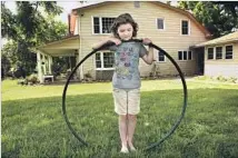  ??  ?? JOY ELIZABETH REILLY, 8, holds a hula hoop the size of the pipeline that would run through the family’s Four Corners Farm.