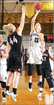  ?? NWA Democrat-Gazette/ANDY SHUPE ?? Taylor Moore (15) of Ozark takes a shot over Maggie Fletcher (44) of Pea Ridge on Wednesday during the 4A-North Regional Tournament at the Tiger Dome in West Fork.